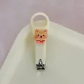 Cortauñas lindo de oso crema, herramienta de manicura portátil de acero inoxidable para niños. - Estilo crema - oso con pajarita