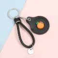 Mini leather smart card case AirTag protective sleeve with black braided strap and keychain. - Cord Bracelet Style / Round Carrot