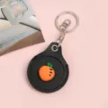 Black leather keychain AirTag protective case with cute carrot charm and metal ring holder - Snap Button Style / Round Carrot