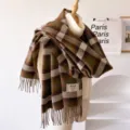 Detailed view of retro brown and green plaid fringe scarf shawl displayed on white turtleneck sweater. - Dark Brown Fringed Plaid / 195*65cm