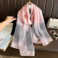 Detailansicht des eleganten rosafarbenen langen Schals mit Strass und Perlen. - Rosa