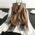 Detailed view of the elegant brown and black silk blend scarf with metallic thread. - Coffee