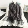 Elegant dark grey silk wool scarf with gold grid pattern and sheer black hem for women. - Dark Gray