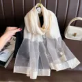 Detailed view of women's silk-blend organza pearl beaded sunscreen long fashion shawl scarf. - Light Beige