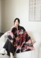 Detailed view of the stylish winter jacquard shawl worn gracefully in a cozy indoor setting. - Black Quicksand Rose