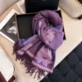 Detailed view of women's purple floral jacquard core-spun yarn scarf with fringe trim. - Purple