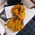 Detailed close-up of the stylish autumn and winter floral patterned soft tassel scarf. - Yellow
