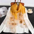 Exquisite embroidered silk wool scarf detail, gradient yellow floral design, luxury fabric. - Gold
