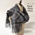 Detailed close-up of grey plaid fringed scarf styled with knit sweater in cozy autumn winter scene. - 195x65cm / Black Tassel Plaid
