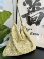 Detailed view of yellow floral cotton canvas shoulder bag with slender straps, cozy style. - Yellow Floral