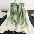 Green silk wool blend scarf detailed view showcasing elegant drape and luxury texture for women. - Light Green