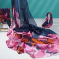Detailed view of elegant navy blue floral print silk scarf with matching hair accessory. - SJT-3
