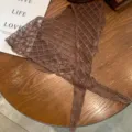 Detail shot of brown lace mesh triangular shawl, lightweight jacquard floral scarf for summer. - Brown