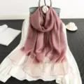Detail view of a luxury striped silk wool shawl scarf in elegant pink, perfect for women's fashion. - Dusky Pink