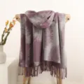 Double-sided feather pattern tassel scarf draped gracefully on a wooden chair display. - Taro Purple