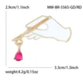 Detailed view of the medical scalpel and hand enamel brooch with red crystal pendant. - Gold Rose Red Pendant (MM-BR-5565-GD/RD) / Gold