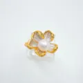 Detailed close-up of a elegant gold-rimmed flower pearl ring on transparent display. - Flower-Small-Ring-Gold (Artificial Pearl) / Ring