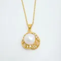 Detailed view of gold-plated pearl pendant necklace with shining cubic zirconia details. - Pendant / Gold (Artificial Pearl)