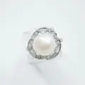 Detail shot of an elegant pearl ring featuring a central white pearl and sparkling zirconia. - Ring / Silver (Acrylic Pearl)