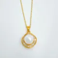 Close-up of gold-plated necklace pendant with central pearl and sparkling baguette stones. - Pendant Only (Without Chain) (Acrylic Bead) / Small / Gold