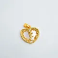 Vista dettagliata del ciondolo a cuore dorato con madreperla e raffinato motivo floreale. - Cuore-Oro-Conchiglia Bianca