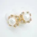 Close-up detail of luxury gold-plated square pearl earrings with sparkling crystal accents. - Geometric Style - Gold - Artificial Pearl