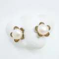 Detail shot of elegant flower pearl stud earrings, featuring glowing gold metal and smooth pearls. - Flower Style - Silver - Acrylic Bead