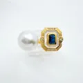 Retro DIY jewelry detail featuring a large white pearl and rectangular gold frame with blue stone. - Sapphire Ring (Acrylic Bead) / Gold