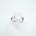 Detailed shot of a chic white pearl ring with silver-tone split band and sparkling accent stones. - Silver (Acrylic Pearl)