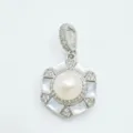 Close-up detail of hexagonal mother-of-pearl pendant with central pearl and crystal pave. - White Shell Pendant (Natural Pearl) / Silver
