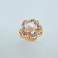 Close-up detail of the elegant floral ring featuring a central pearl and sparkling cubic zirconia. - Sprout Ring Freshwater Pearl