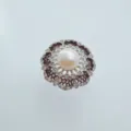 Detailed close-up of a vintage hollow pearl ring with sparkling zircon stones and shiny metal. - Silver Lace Ring Freshwater Pearl
