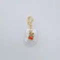 Detailed close-up of a baroque freshwater pearl pendant with gold-plated clasp and colorful stones. - Square Star Style