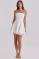 Detailed view of the white strapless lace mini dress, highlighting the exquisite cutout fabric. - S / Dresses / White