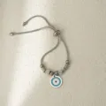 Pulsera ajustable de acero inoxidable con colgante de mal de ojo y detalles de estrás - Ojo Redondo Plateado
