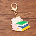 Graduation season metal alloy keychain charm with stacked books and pink flowers design. - 1 Piece (28x28mm) With Lobster Clasp