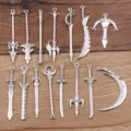 Close-up details of antique silver alloy weapon charms and miniature sword pendants for DIY crafts. - Set of 10 / Antique Silver