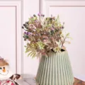 Artificial plastic flower bouquet with berries and leaves, stylish green vase for home decor. - Purple