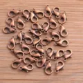 Detailed close-up shot of bronze alloy lobster clasps, perfect for DIY jewelry making and crafts. - Red Bronze