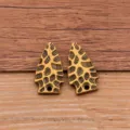 Close-up of alloy arrowhead pendants with hammered texture, perfect for DIY jewelry making. - Bronze