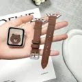 Detail shot of brown leather watch strap for Apple Watch, featuring cute embossed bear design. - 38/40/41mm (S10 42mm) / Brown