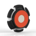 Close-up view of the magnetic AirTag protective case with black, white and orange details. - Black