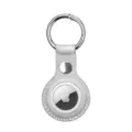 Detail shot of silver leather protective case with metal keychain ring for tracking device. - Silver White