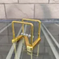 Detailed view of metal Newton cradle balance balls, gold frame desk toy for home office decor. - Z-Shaped / Gold