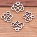 Close-up detail of silver alloy heart charms, ideal for DIY jewelry and bag accessories. - Antique Silver