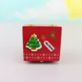 Wooden Christmas music box detail view, red festive design with cute tree and holiday tag. - Christmas Tree (Clockwork)