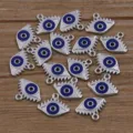 Close-up details of silver tone enamel evil eye alloy charms pendants for DIY jewelry making. - Silver