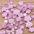 Close-up detail of mixed pink resin rose flower and bow flatback cabochons for DIY crafts. - 30g Pack / Purple