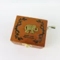 Exquisite wooden hand crank music box with cute elephant design and vintage melody text. - Elephant