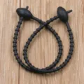Black reusable silicone cable tie with oval head, flexible rubber strap for cord management. - Black